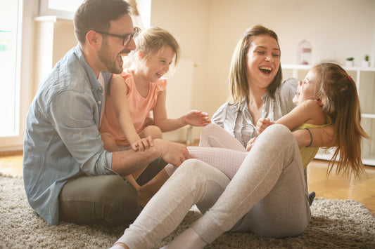 Happy family playing on floor