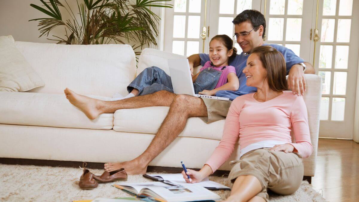 Family of three enjoying time together in living room